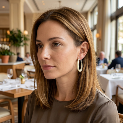 Modelka z kremowym kolczykiem kółkiem w restauracji